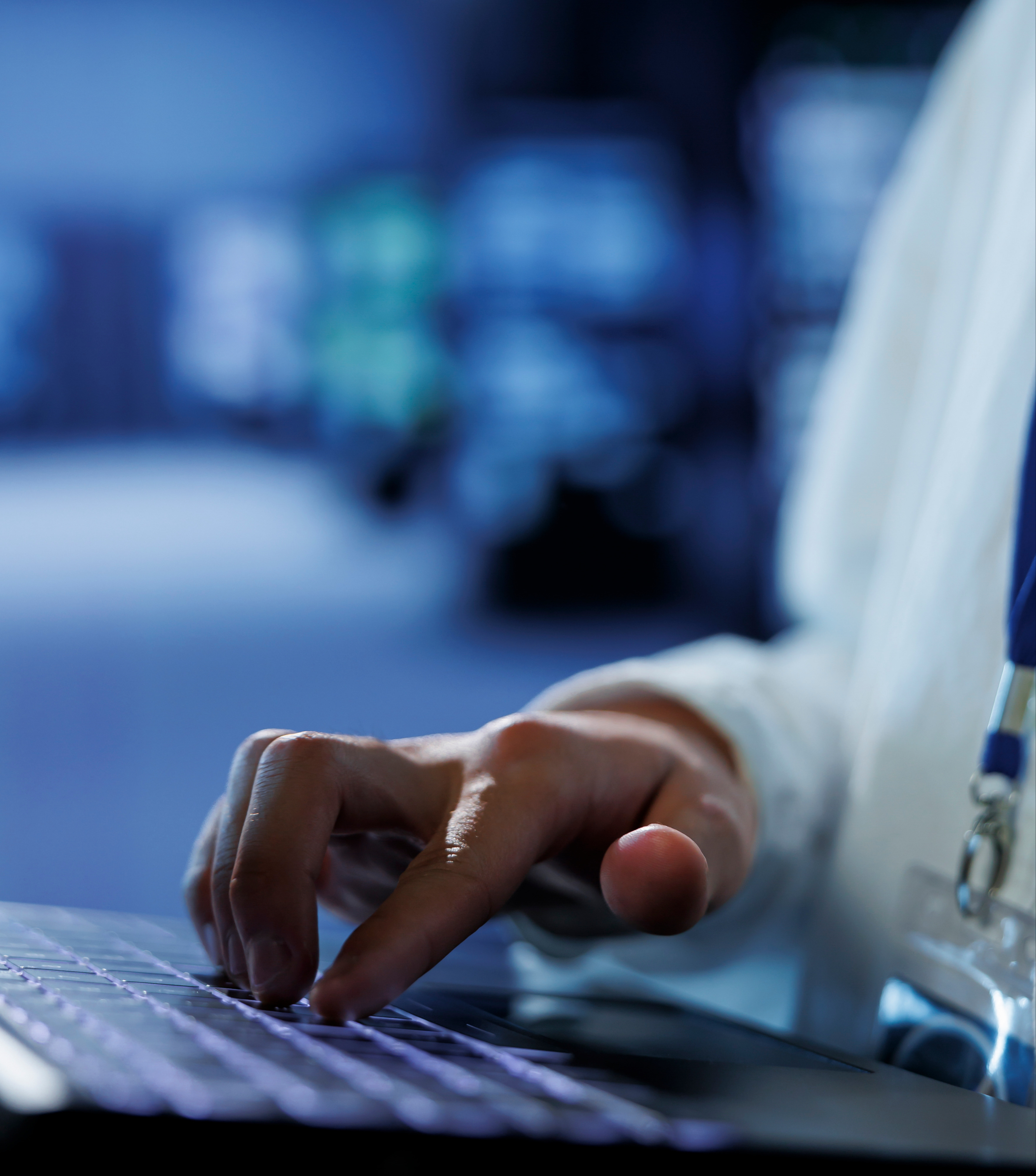 knowledgeable-admin-data-center-uses-laptop-prevent-system-overload-peak-traffic-periods-adept-expert-server-hub-ensuring-enough-network-bandwidth-smooth-operations-close-up